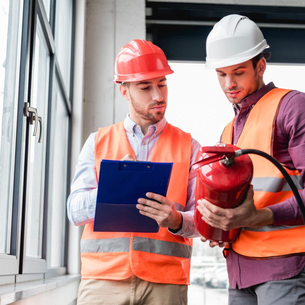 firemen-in-helmets-standing-and-looking-at-red-ext-2021-08-30-01-44-56-utc-min